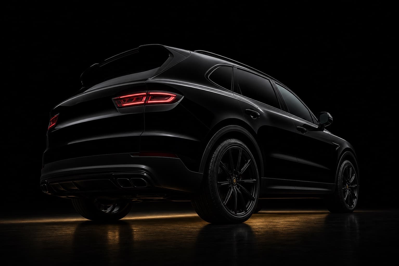 A black SUV seen from the rear three-quarter, its refinished paintwork catching a low amber light