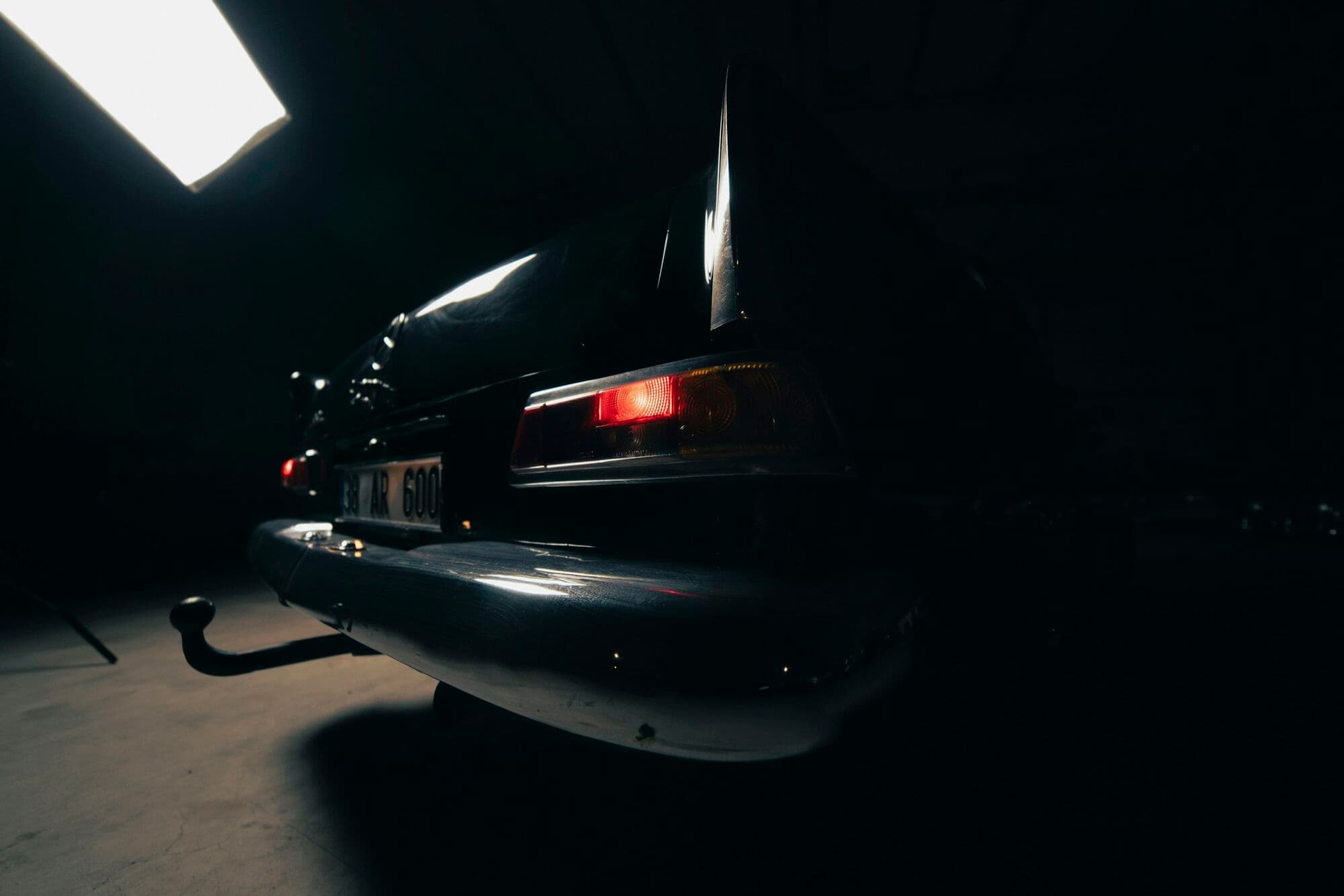 A vehicle under a single skylight on the Bartels Autocare workshop floor